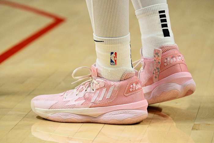 View of Damian Lillard's pink adidas shoes.